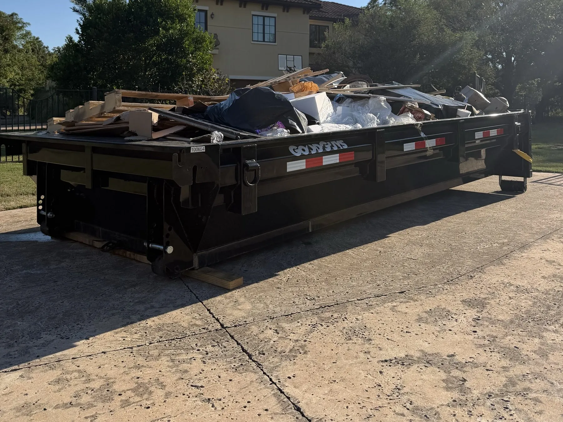 Loaded low-sided dumpster ready for pickup