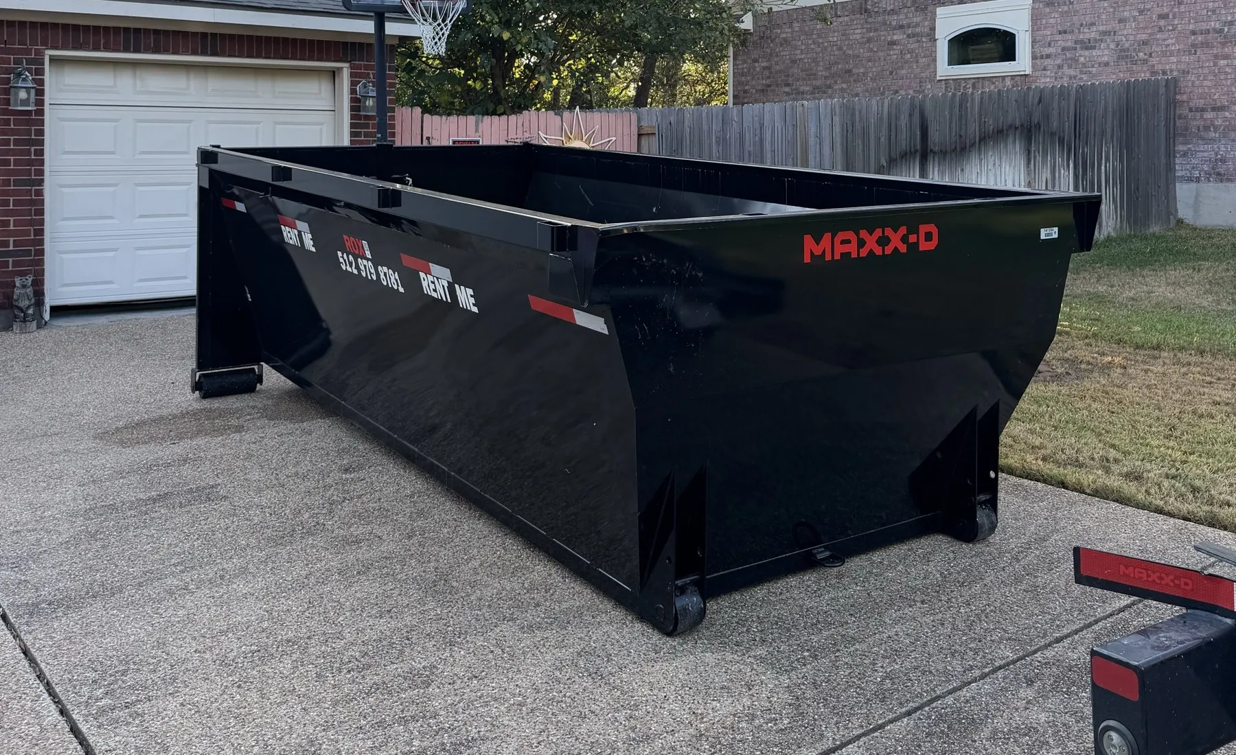 Capital RollOffs dumpster on a residential driveway